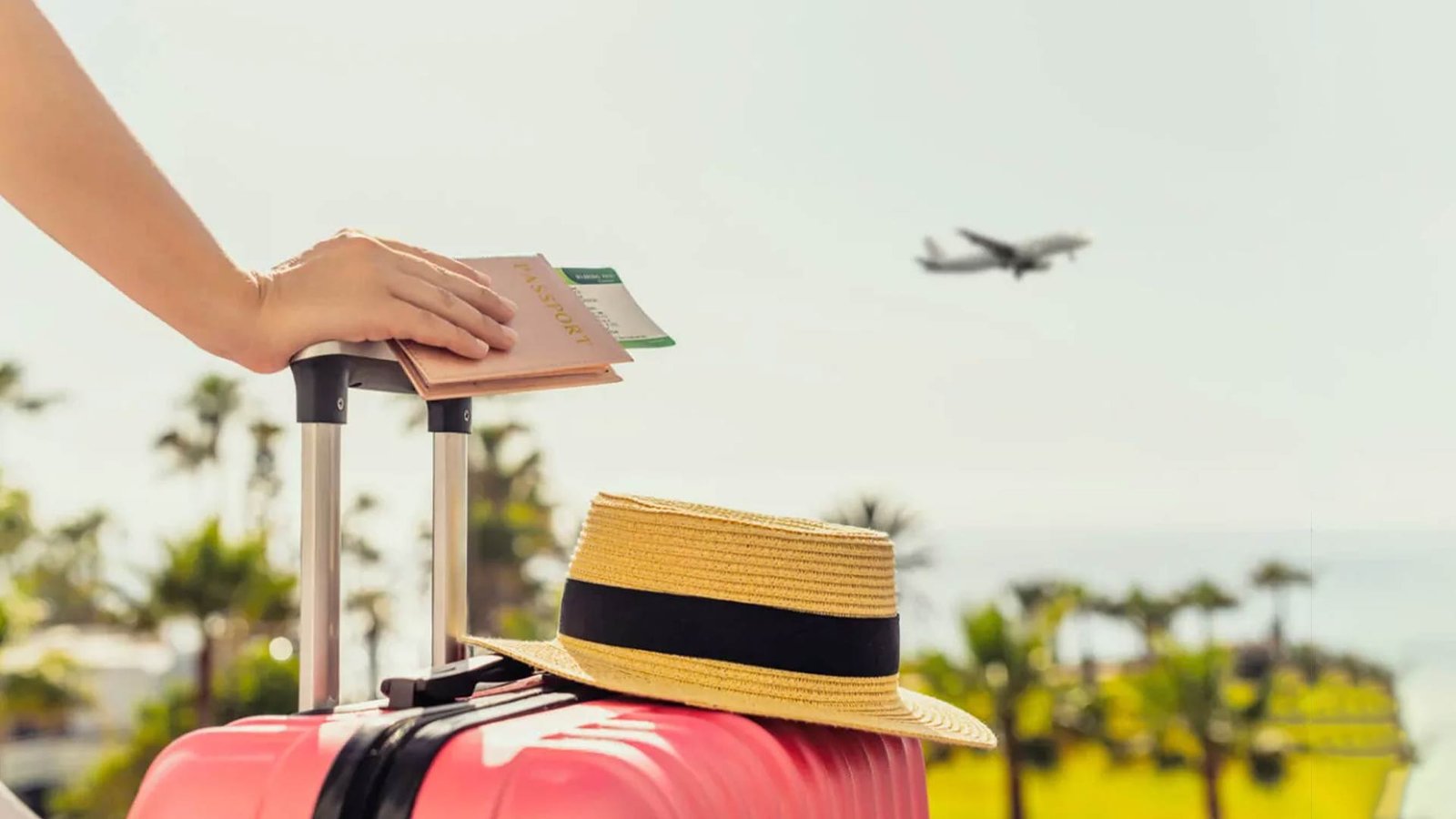 Traveler preparing for a flight with a suitcase, passport, and sun hat, highlighting the importance of an Oman travel packing list that includes travel essentials for safety and comfort.