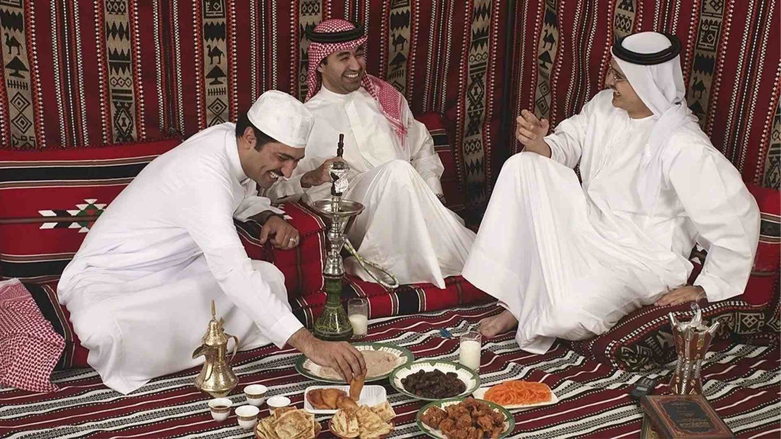 Omani hospitality traditions: men sharing a meal and tea in a traditional Majlis