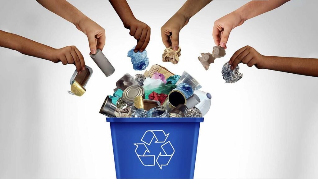 Hands placing various recyclable items into a blue recycling bin, symbolizing the efforts to reduce waste and conserve resources, which are key practices in promoting Eco-Tourism in Oman.