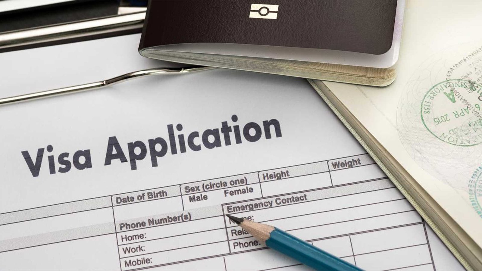 Close-up of a visa application form with a pen and passport, highlighting the process involved in meeting Oman visa requirements for travel to the Sultanate.